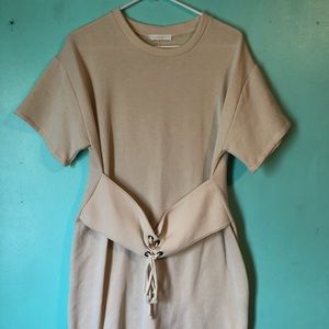 Fitted blush color dress with corset like belt.